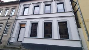 a white building with many windows on it at Monteurzimmer 05 in Parchim in Parchim