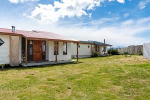 a row of houses in a yard at Kayenwuouk, Puerto Natales in Puerto Natales