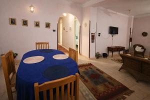 a dining room with a blue table in a living room at Top View in Luxor