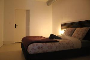 a bedroom with a bed with a cross on the wall at Troglodyte Baths natural coolness in Saint-Étienne-de-Chigny