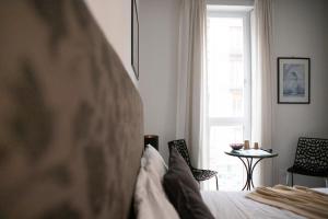 a bedroom with a bed and a window and a table at G House in Bologna