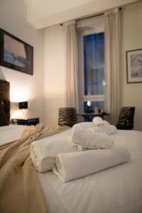 a room with two beds with towels on them at G House in Bologna