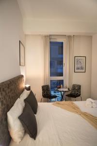 a bedroom with a bed and a table and chairs at G House in Bologna