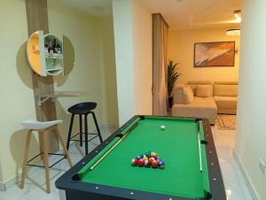 a living room with a pool table and a couch at Lushplus Living in Mama