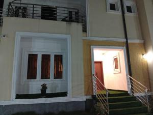 a building with a staircase leading up to a door at Lushplus Living in Mama