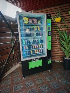 a vending machine with drinks and drinks in it at Aerohostal in Santiago