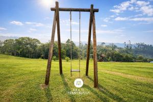 a swing in the middle of a field at Chalé do Campinho - Rancho Queimado/SC in Rancho Queimado +26 photos