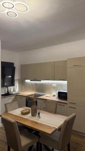 a kitchen with a wooden table with chairs around it at Morea Apartments in Ulcinj