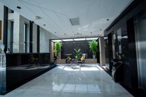 a hallway with tables and chairs in a building at شقق جلف نايت للشقق المخدومة in Riyadh