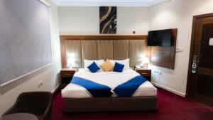 a hotel room with a bed and a tv at Maidan Al Bait in Mecca +39 photos