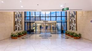 a lobby of a building with potted plants at Maidan Al Bait in Mecca