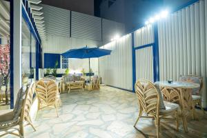 a patio with chairs and a table with an umbrella at شقق جلف نايت للشقق المخدومة in Riyadh