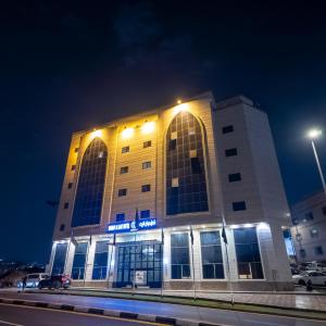 a building with lights on top of it at night at Maidan Al Bait in Mecca