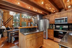 a large kitchen with wooden cabinets and appliances at Creekside Retreat in Whitefish