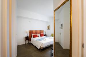 a bedroom with a bed and a mirror at G House in Bologna