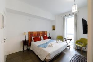a bedroom with a bed with red pillows and a television at G House in Bologna +63 photos