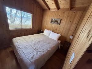 a bedroom with a bed in a wooden cabin at Boulder Creek RV Resort in Lone Pine +67 photos