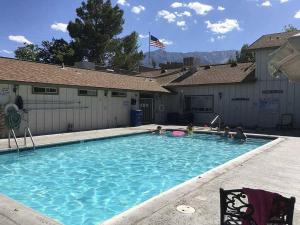 a group of people sitting in a swimming pool at Boulder Creek RV Resort in Lone Pine