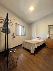 a bedroom with a bed and a room with a fan at Casa Dos Avenidas 4 Dormitorios in Montevideo