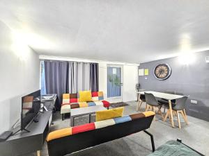 a living room with a couch and a table at Hidden Putney-Studio Flat in London