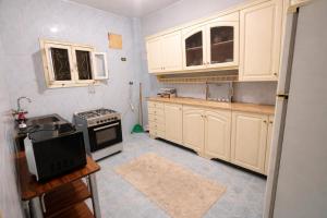 a kitchen with white cabinets and a stove at Top View in Luxor +15 photos