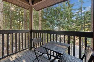 a porch with two chairs and a table at Nordic Nook in Whitefish +27 photos