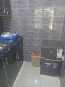 a small kitchen with a sink and a trash can at Nova apartments in Amdalai +16 photos