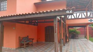 an entrance to a house with a pergola at Sobrado em Coroados, Guaratuba PR in Guaratuba