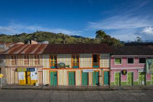a group of buildings with colorful doors and windows at Hostal Casa Celeste in Murillo +45 photos