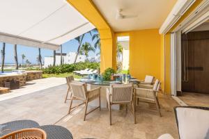a dining room with a table and chairs and the ocean at Exclusive Oceanfront Apartment Beach access in Acapulco
