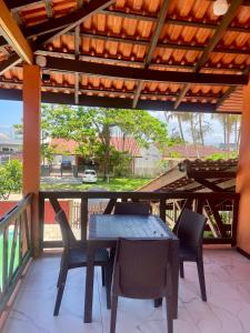 a patio with a table and chairs on a balcony at Sobrado em Coroados, Guaratuba PR in Guaratuba
