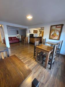 a dining room and living room with a table and chairs at Tierra & Vino a pasos Museo y Casino in Santa Cruz