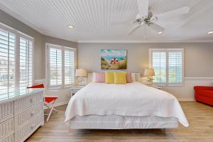 a bedroom with a bed and a ceiling fan at HB303 My Flippin' House in Holden Beach