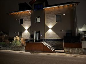 a building with lights on the side of it at night at Liya Apartments in Aiterhofen