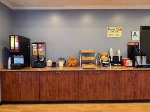 a counter with food on top of a restaurant at Super 8 by Wyndham El Cajon San Diego in El Cajon