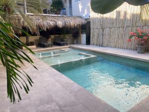 a swimming pool next to a building with at Ashly Boulevard in Acapulco