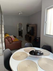 a living room with three tables and a couch at Duplex premium com garagem perto do centro 5 hósp. in Garanhuns