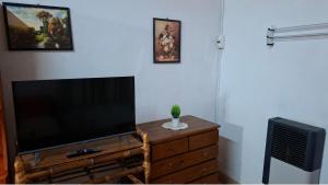 a flat screen tv sitting on top of a wooden dresser at Posada Ernesto in Rauch