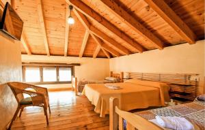 a room with two beds and a table in it at Casa Rural Montion in Jimera de Líbar