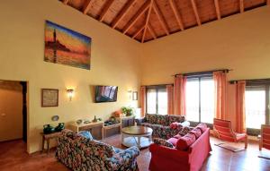 a large living room with couches and a tv at Casa Rural Montion in Jimera de Líbar