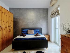 a bedroom with a king sized bed with blue sheets at Modern House with Pool - 10 Guests Max in Taʼ Ċantar +21 photos