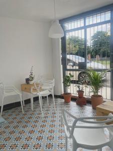 a room with chairs and a table and windows at Akaiah in Santo Domingo