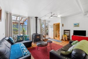 a living room with a couch and a fireplace at Moonah on Mawson in Anglesea
