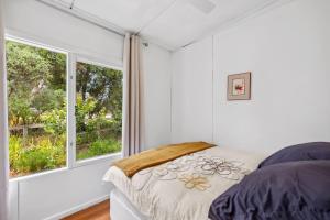 a bedroom with a bed and a window at Moonah on Mawson in Anglesea