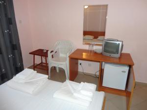 a small room with a desk and a television at Sargas Sozopol in Sozopol