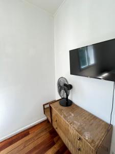 a room with a table with a fan on a wall at BbCasita Blue-Hostal in Santiago