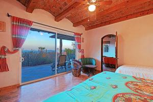 a bedroom with a bed and a window with a view at Ventana Bay Resort in La Ventana