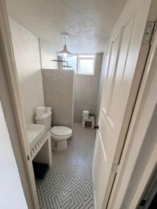 a bathroom with a toilet and a sink at Soul Home in Momoxpan +14 photos
