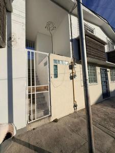 a fence on the side of a building at Soul Home in Momoxpan