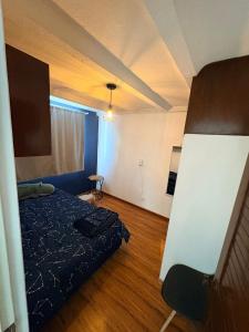 a small room with a bed and a chair at Soul Home in Momoxpan